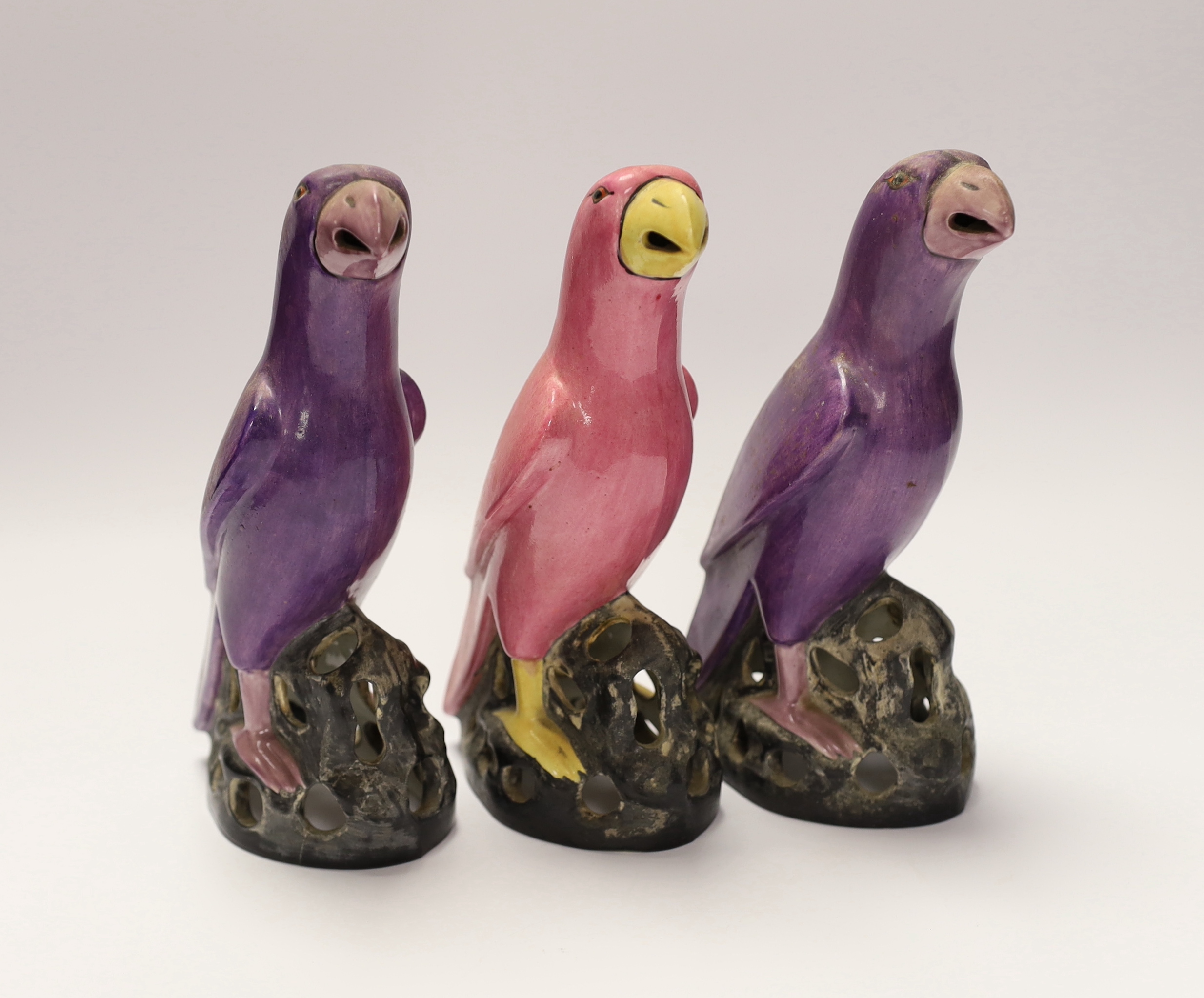 Three Crown Staffordshire parrots with purple and pink glazed, each stamped, 19cm high